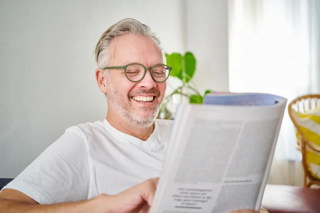 Manfred Sandner, founder and managing director of Cronema, smiling with a magazine